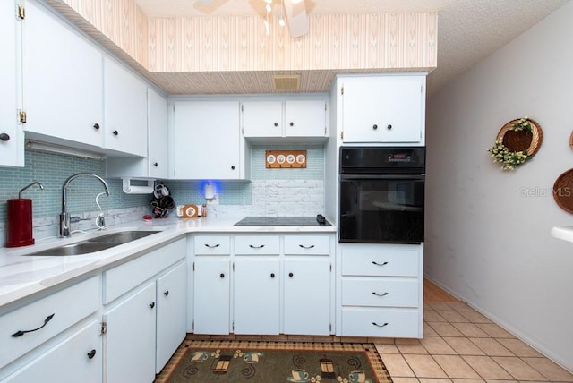 kitchen featuring white cabinetry, tasteful backsplash, black appliances, and sink