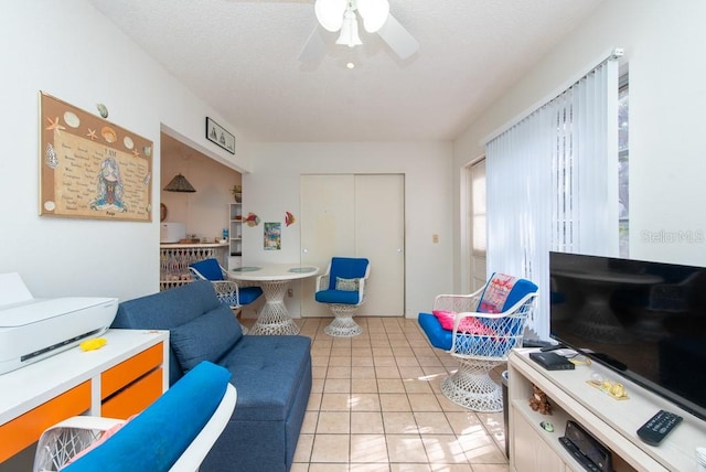 tiled living room with ceiling fan