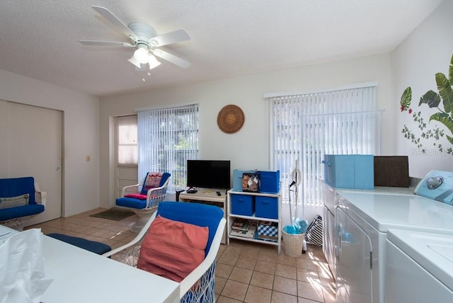 bedroom with light tile patterned floors, washing machine and dryer, and ceiling fan