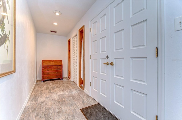 corridor with light hardwood / wood-style flooring