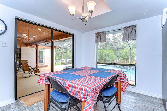 dining space featuring wood ceiling, hardwood / wood-style flooring, and a notable chandelier