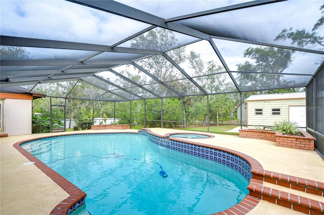 view of swimming pool with a shed, glass enclosure, an in ground hot tub, and a patio area