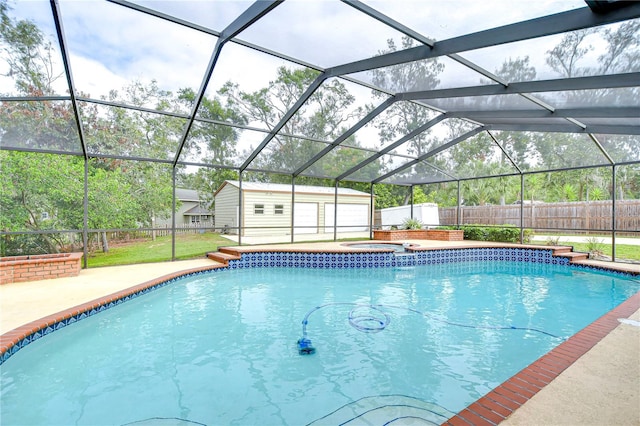 view of swimming pool featuring a patio, a lanai, a storage unit, and an in ground hot tub