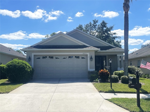 single story home featuring a front yard and a garage