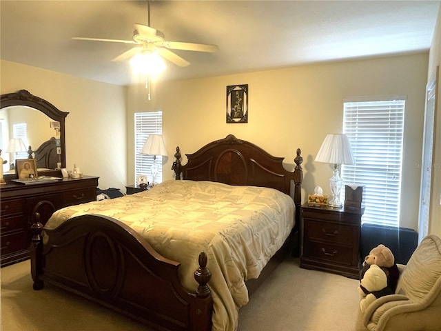 carpeted bedroom featuring multiple windows and ceiling fan