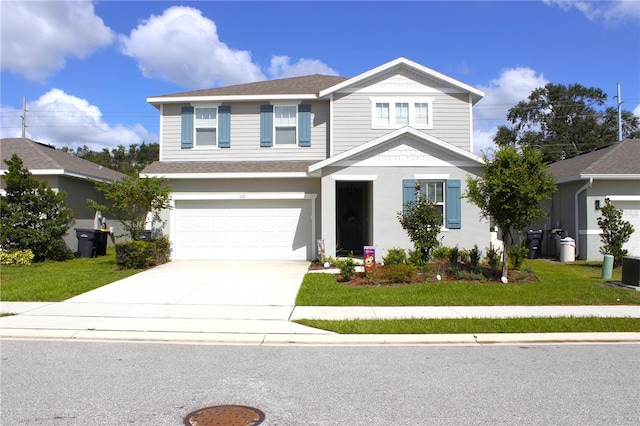 view of front of home with a front lawn and a garage