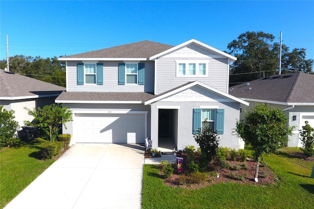 view of property with a front yard and a garage