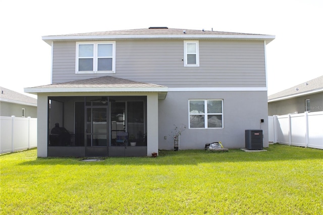 back of property featuring a yard, central air condition unit, and a sunroom