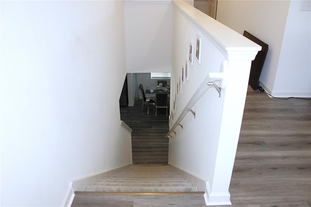 stairs with wood-type flooring