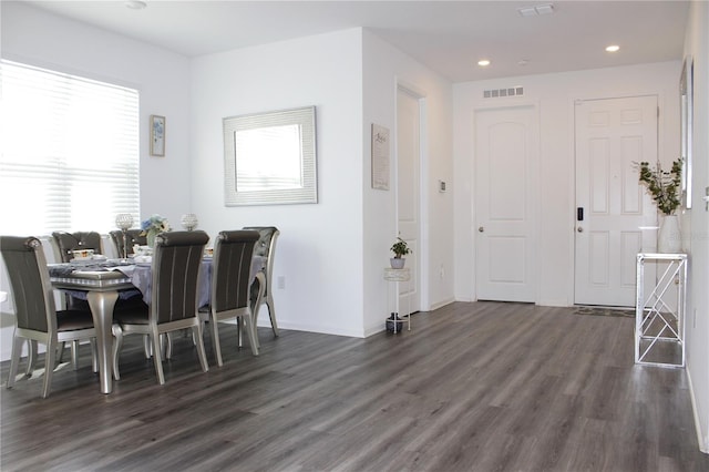 dining space featuring a wealth of natural light and dark hardwood / wood-style flooring