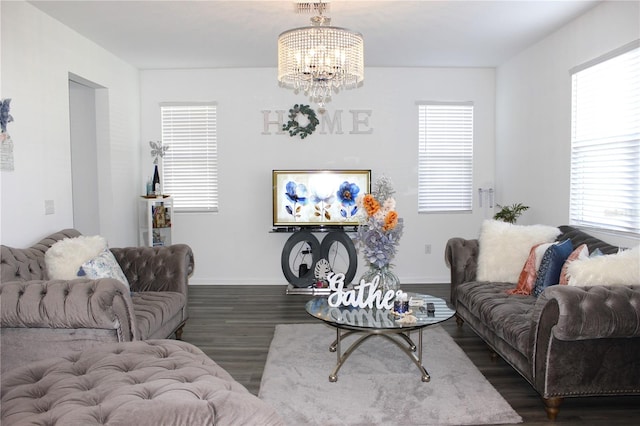 living room featuring a notable chandelier and dark hardwood / wood-style flooring