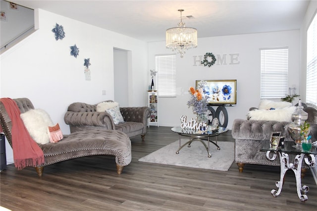 living room with a notable chandelier and dark hardwood / wood-style flooring