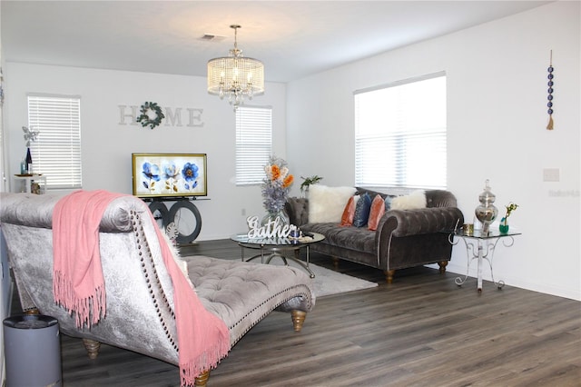 living room with an inviting chandelier and dark hardwood / wood-style flooring