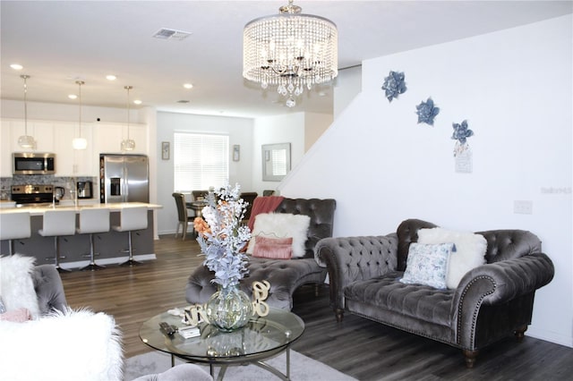 living room with a chandelier and dark hardwood / wood-style flooring