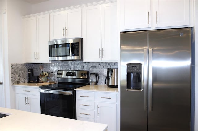 kitchen featuring white cabinetry, tasteful backsplash, and appliances with stainless steel finishes