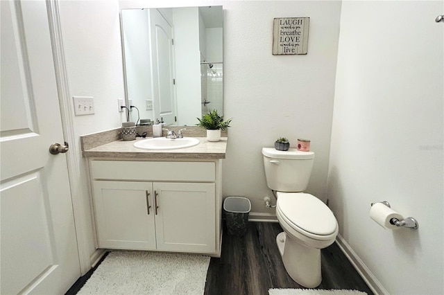 bathroom with vanity, hardwood / wood-style floors, and toilet