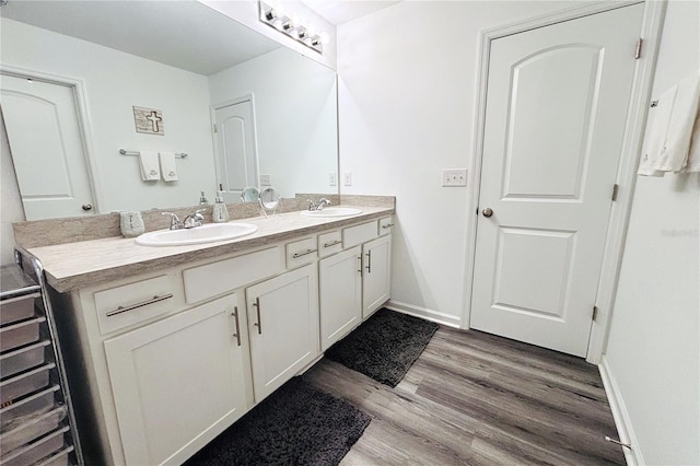 bathroom with vanity and wood-type flooring