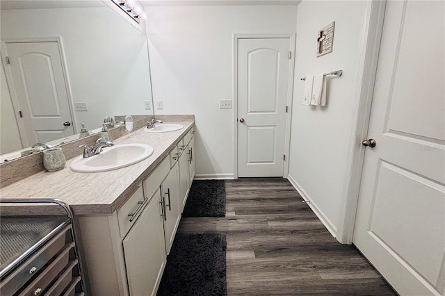 bathroom with vanity and hardwood / wood-style flooring