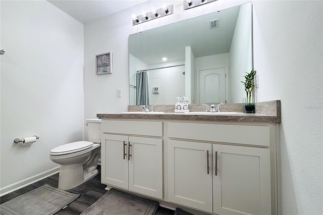 bathroom with vanity, toilet, a shower with curtain, and hardwood / wood-style floors