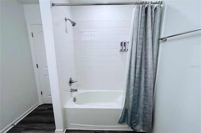 bathroom featuring hardwood / wood-style floors and shower / bathtub combination with curtain