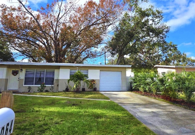 single story home featuring a garage and a front yard