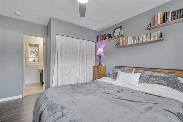 bedroom with a textured ceiling, ensuite bath, ceiling fan, and dark hardwood / wood-style floors