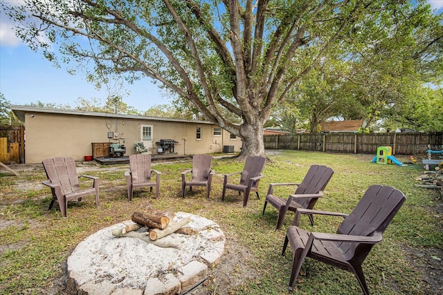 view of yard with a fire pit