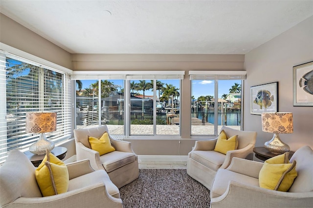 sunroom featuring a healthy amount of sunlight and a water view