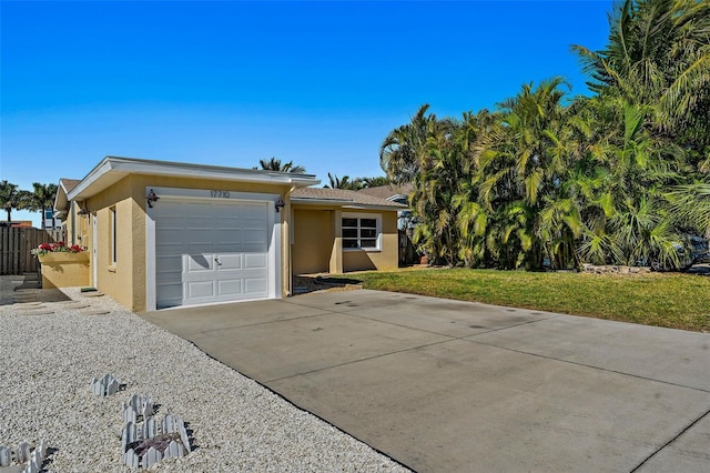 ranch-style home with a front yard and a garage