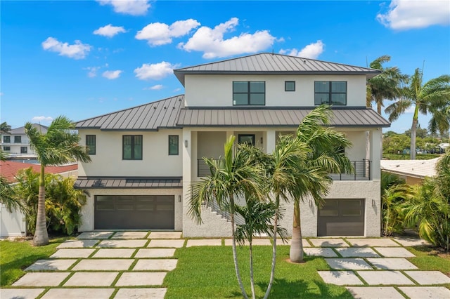 view of front of property with a balcony and a garage