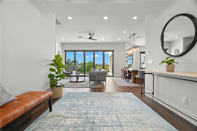 living room with ceiling fan and dark hardwood / wood-style floors