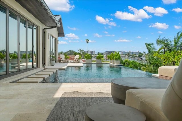 view of swimming pool featuring pool water feature and a patio area