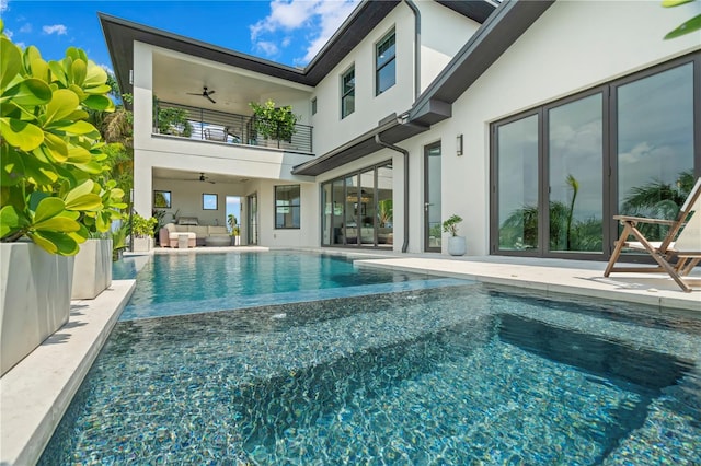 view of pool with outdoor lounge area, ceiling fan, and a patio