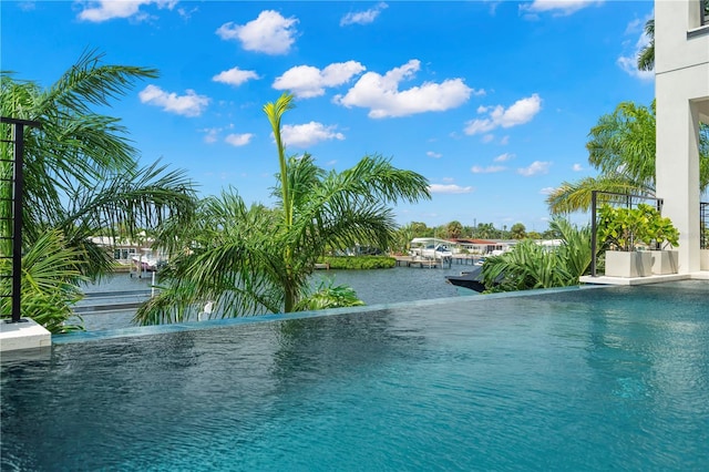 view of swimming pool with a water view