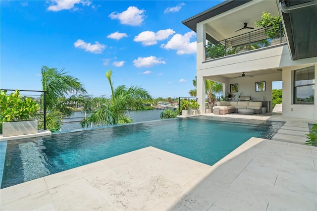 view of pool featuring an outdoor hangout area, a water view, a patio, and ceiling fan