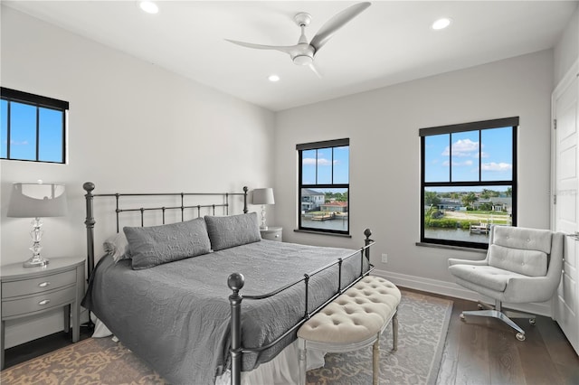 bedroom with ceiling fan and dark hardwood / wood-style floors