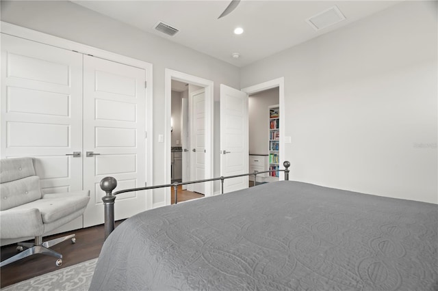 bedroom featuring ceiling fan, wood-type flooring, and a closet