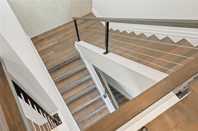 stairway with hardwood / wood-style floors