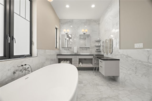 bathroom with vanity, a bathtub, and tile walls