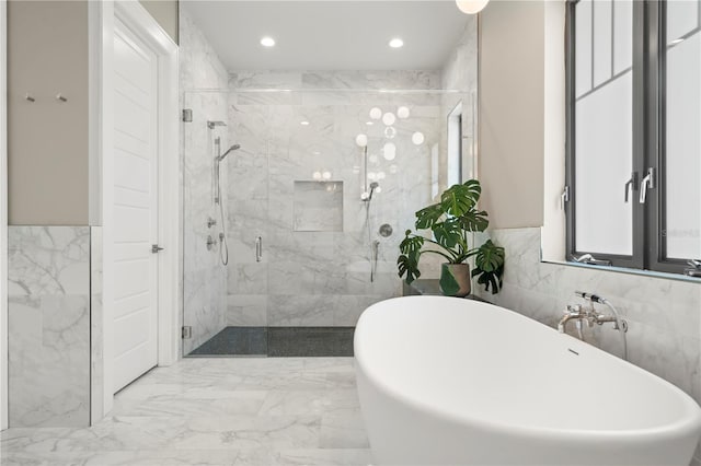 bathroom featuring separate shower and tub and tile walls