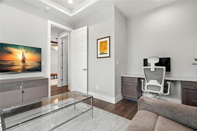 interior space with built in desk, dark hardwood / wood-style floors, and ornamental molding