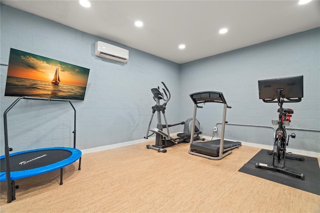 workout room with a wall mounted air conditioner