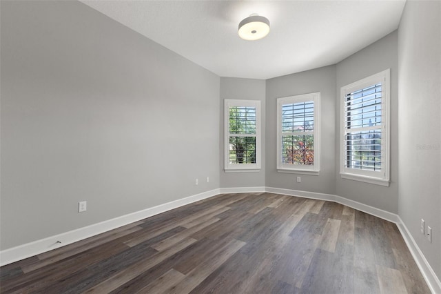 spare room with dark hardwood / wood-style floors