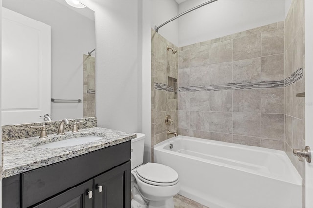 full bathroom featuring vanity, toilet, and tiled shower / bath