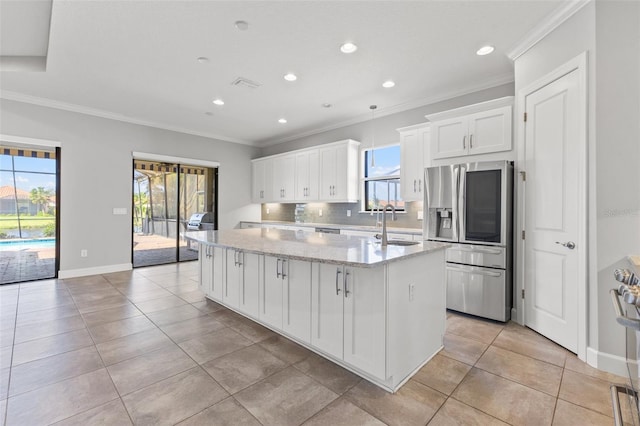 kitchen featuring white cabinetry, stainless steel refrigerator with ice dispenser, a kitchen island with sink, and light stone counters