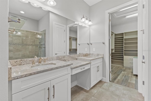 bathroom with vanity, wood-type flooring, and an enclosed shower