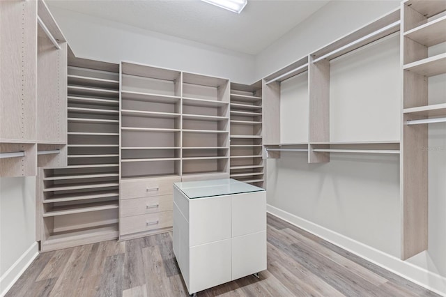 spacious closet featuring light hardwood / wood-style floors