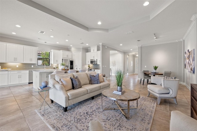 living room featuring light tile patterned floors, visible vents, a raised ceiling, arched walkways, and recessed lighting