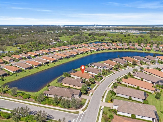 birds eye view of property featuring a water view and a residential view