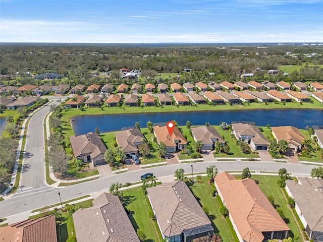 bird's eye view featuring a water view and a residential view